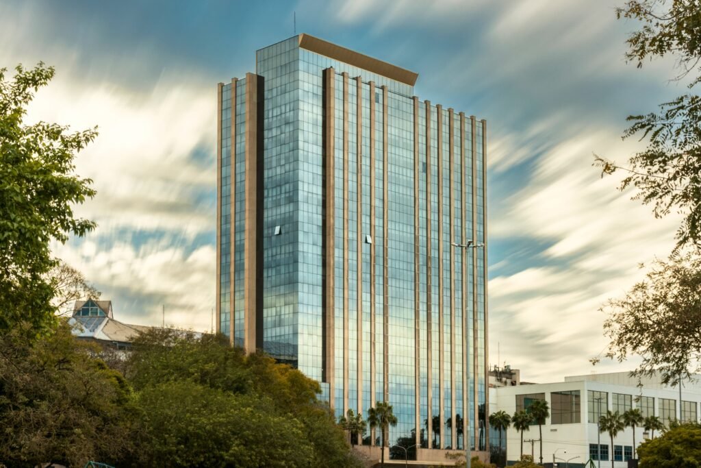 Skyscraper with reflective glass facade in Porto Alegre on a cloudy day.